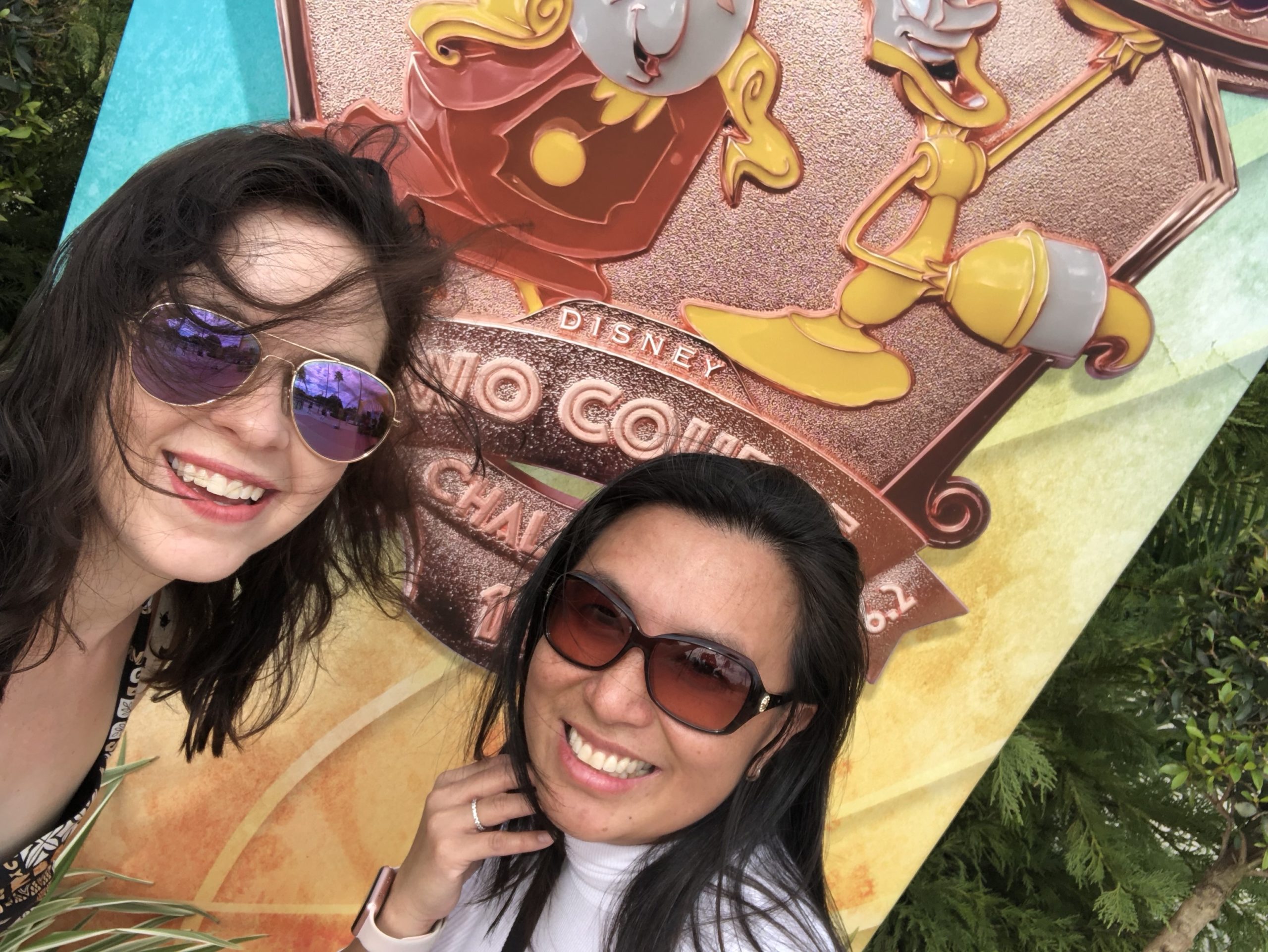 Jenn and Erika with WDW Wine & Dine Two Course Challenge sign